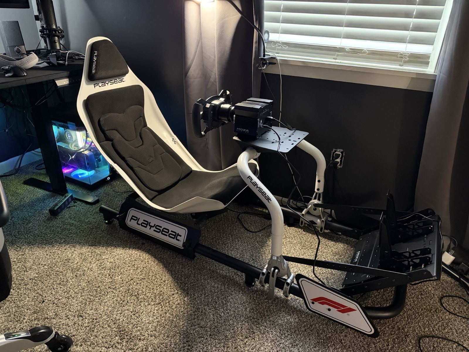 The Playseat Formula Instinct in its first week: white shell, a Moza R5 base and CS wheel on the wheel deck, pedals at the front, nothing else mounted.