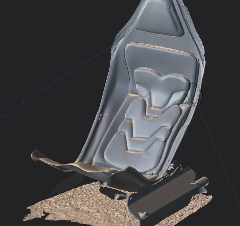 A 3D scan of the Playseat seat shell open in Plasticity, with the scanned floor still attached underneath.